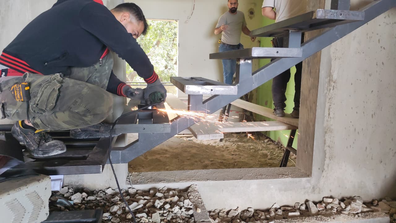 Continuum Design & Contracting crew welding a steel staircase on site